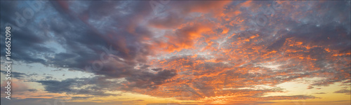 Fiery sunset, colorful clouds in the sky Wallpaper Mural