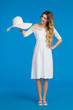 © studioloco - Woman In White Dress Is Presenting Sun Hat