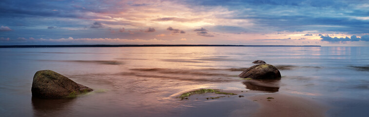 Rocky shores at the sea in sunset light. Lahemaa natural park coastal landscape with beautiful sky