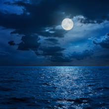 Full Moon In Clouds Over Sea In Night