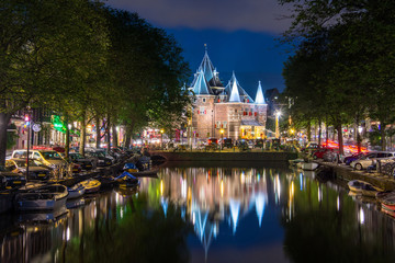 Amsterdam at night, with flowers and bicycles on the bridge, Holland, Netherlands.