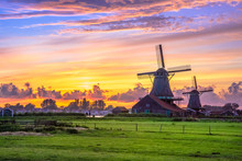 Traditional Village With Dutch Windmills And River At Sunset, Holland, Netherlands.