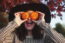 A Young Man With Small Pumpkins Over His Eye Making A Funny Face