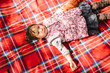 © Maa Hoo/Stocksy - Cute toddler girl lying on picnic mat