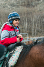 A Happy Child Riding Horseback
