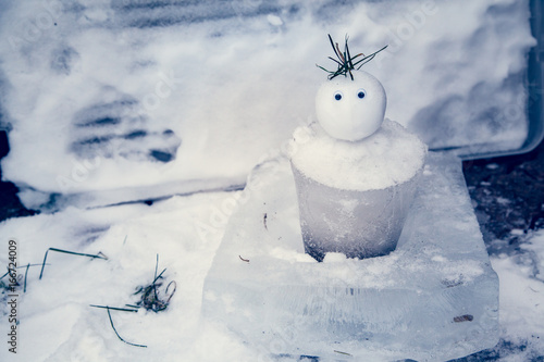 Tiny Snowman with an ice bucket for a body welcomes winter and has a surprised expression Tableau sur Toile