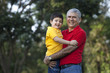 © IndiaPix - Portrait of grandfather and grandson in a park