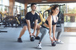 © Friends Stock - Young couple exercise together in gym healthy lifestyle