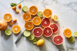 © Trent Lanz/Stocksy - Cut citrus fruits for health and wellness on table