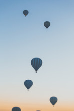 Balloons During Sunrise Over The Desert
