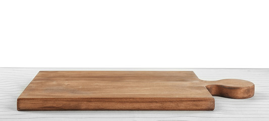 Wooden board on tablecloth against white background