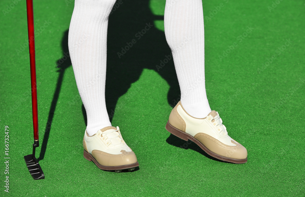 Female golf player at course in sunny day