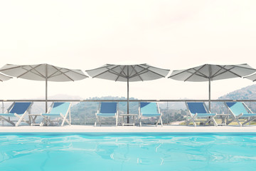 Wall Mural - Blue deck chairs, umbrellas, mountains