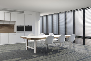 White kitchen with two stoves and a table side