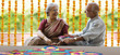 © IndiaPix - Old couple making a rangoli