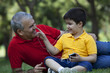 © IndiaPix - Grandson touching his grandfathers nose
