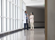© IndiaPix - Doctor discussing patient care in hospital corridor