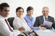 © IndiaPix - Portrait of mature businesswoman smiling with other executives