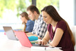 © Antonioguillem - Three students studying on line in a classroom