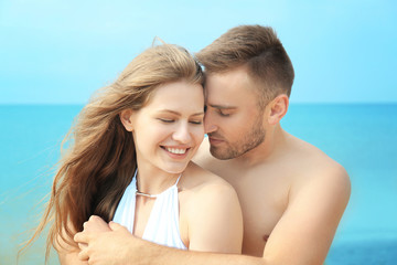 Poster - Young loving couple on seashore