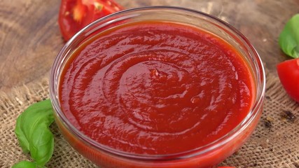 Wall Mural - Portion of Tomato Ketchup rotating on a wooden plate (not loopale; 4K)