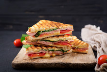 Club Sandwich Panini With Ham, Tomato, Cheese And Basil.