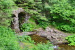 © Kyrylo - Stone arch on the background of trees