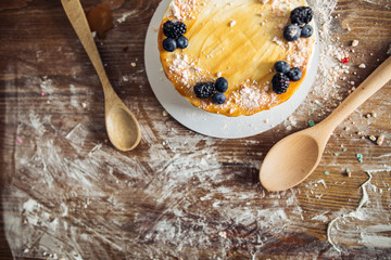 Wall Mural - carrot cake with walnuts, prunes and dried apricots on a dark wood background. tinting. selective focus