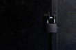 black padlock on rusty metal door with copy space