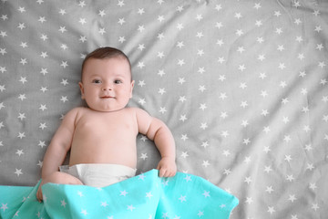 Wall Mural - Cute little baby lying on bed at home