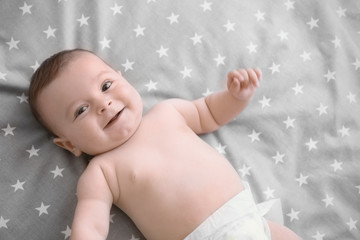 Wall Mural - Cute little baby lying on bed at home