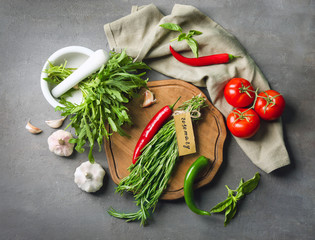 Wall Mural - Composition with fresh herbs and vegetables on grey background