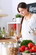 © lenets_tan - Cooking woman in kitchen with wooden spoon