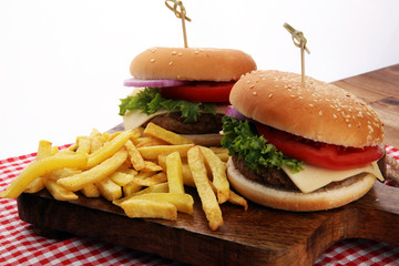 fresh tasty burger and french fries on wooden table