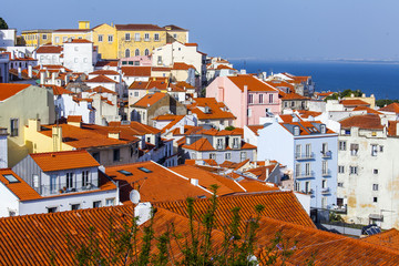 LISBON, PORTUGAL, on June 15, 2017. Summer day. The sun lights red roofs of in downtown on a hill slope 