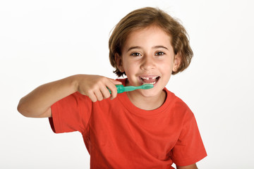 Wall Mural - Happy little girl brushing her teeth with a toothbrush