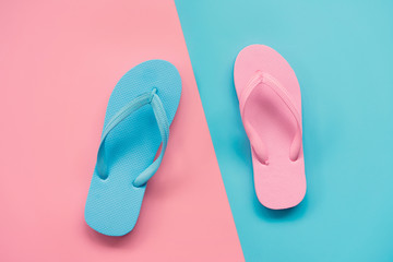 pink and blue sandals on pink and blue pastel background. Lover and Summer concept with copy space.