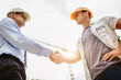 © Aliaksandr Barouski - Architect engineer shaking hands other hand at construction site.  Business teamwork, cooperation, success collaboration concept