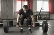 © lenblr - Young man doing deadlift exercise at gym.
