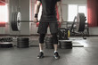 © lenblr - Young man doing deadlift exercise at gym.