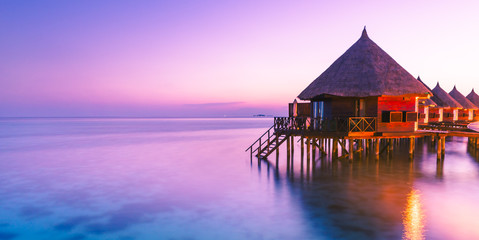 Wall Mural - Water bungalow. Sunset on the islands of the Maldives. A place for dreams.