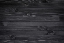 Dark Black Wood Texture Background Viewed From Above. The Wooden Planks Are Stacked Horizontally