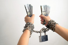 Woman Hands In A Steel Chains And Dollars