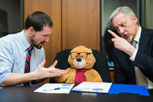Business People Complaining To A Teddy Bear