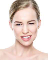 Wall Mural - pretty girl with blue eyes and blond hair, with naked shoulders, looking at camera with cheeky attit