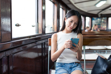 Sticker - Woman sending sms on mobile phone and taking ferry