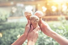 Three Young Woman Hands Holding Ice Cream Cones On Summer