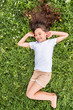© Yakobchuk Olena - Happy little girl lying on green grass