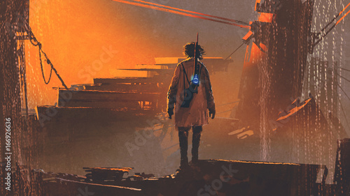 Man With Futuristic Gun Standing In Abandoned City At Sunset