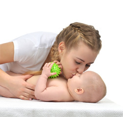 Young mother woman holding and kissing in her arms new born infant child baby kid